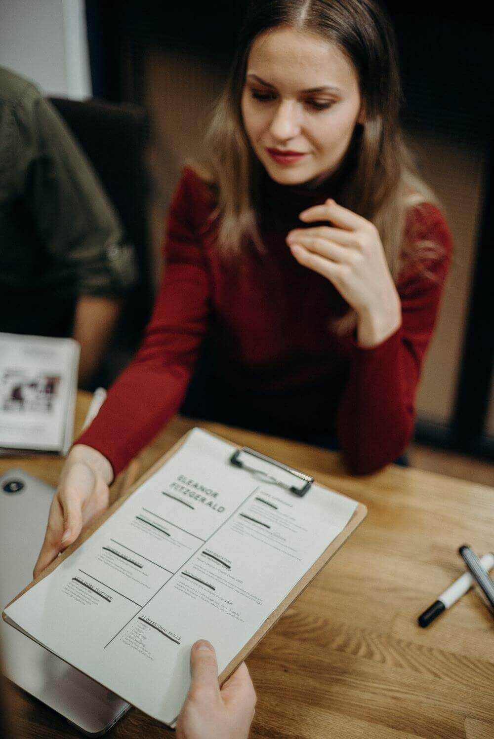 Employee at a job interview showing off her CV